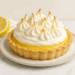 Lemon meringue pie with toasted meringue peaks on a marble surface
