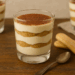 Individual tiramisu parfait with mascarpone cream and cocoa dusting